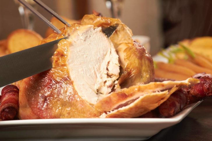 Close Up Of Cooked Chicken Being Carved